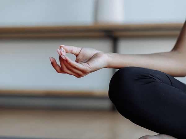 Close-up of hands in a meditative mudra gesture.